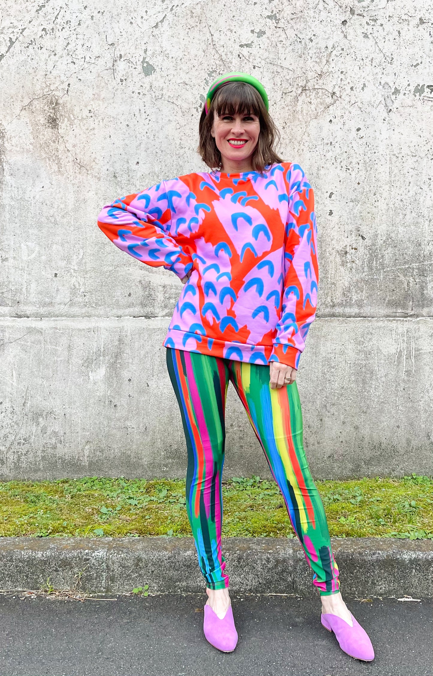 Katie wearing red, pink and blue paint sweatshirt